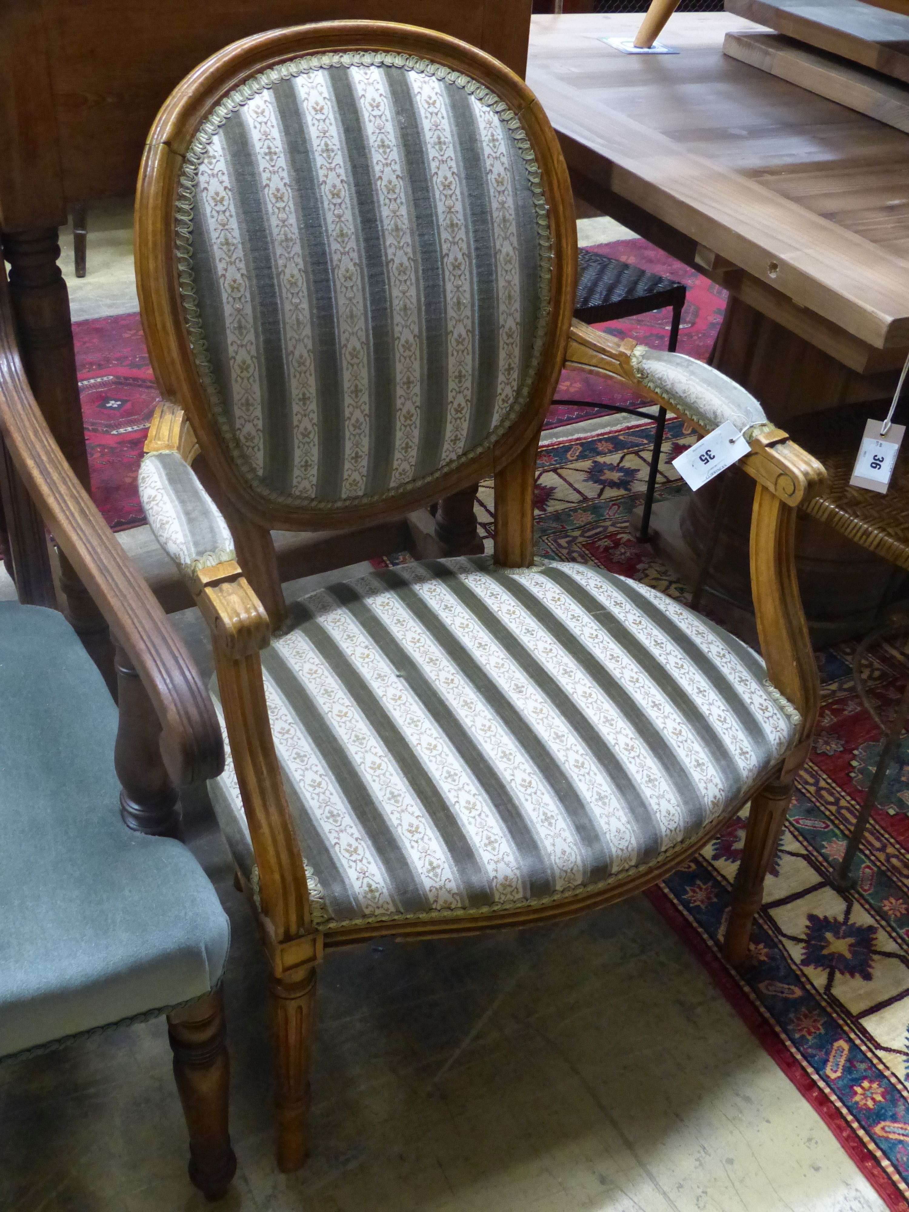 A Louis XVI design upholstered open armchair